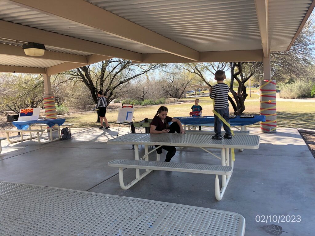 kids at tables outside with decorations