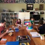 kids doing school work at their home table