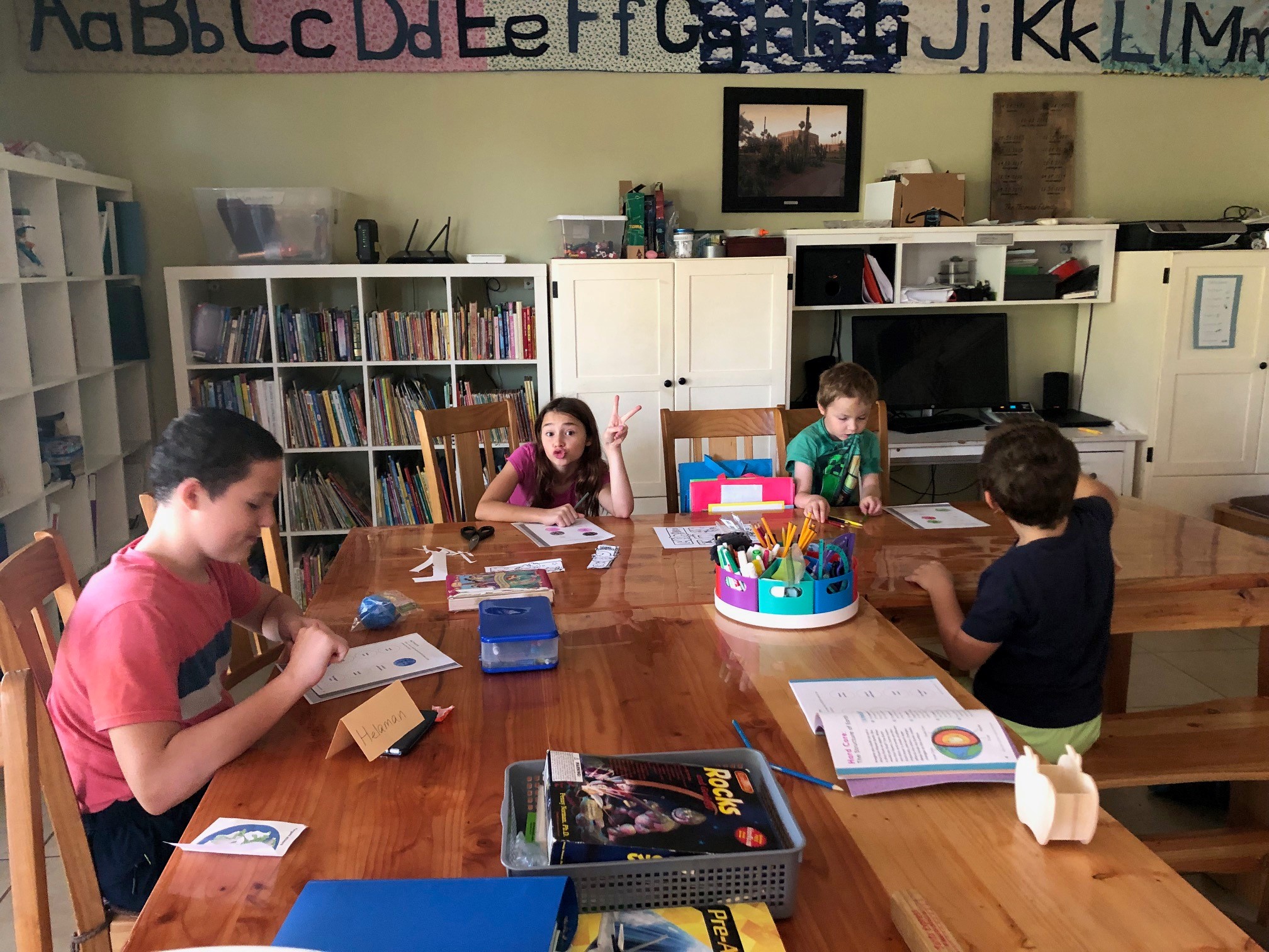 kids doing school work at their home table