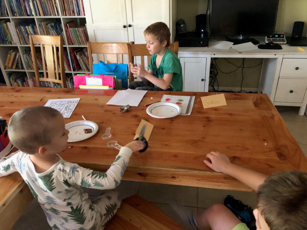 kids at a table doing a homeschool project