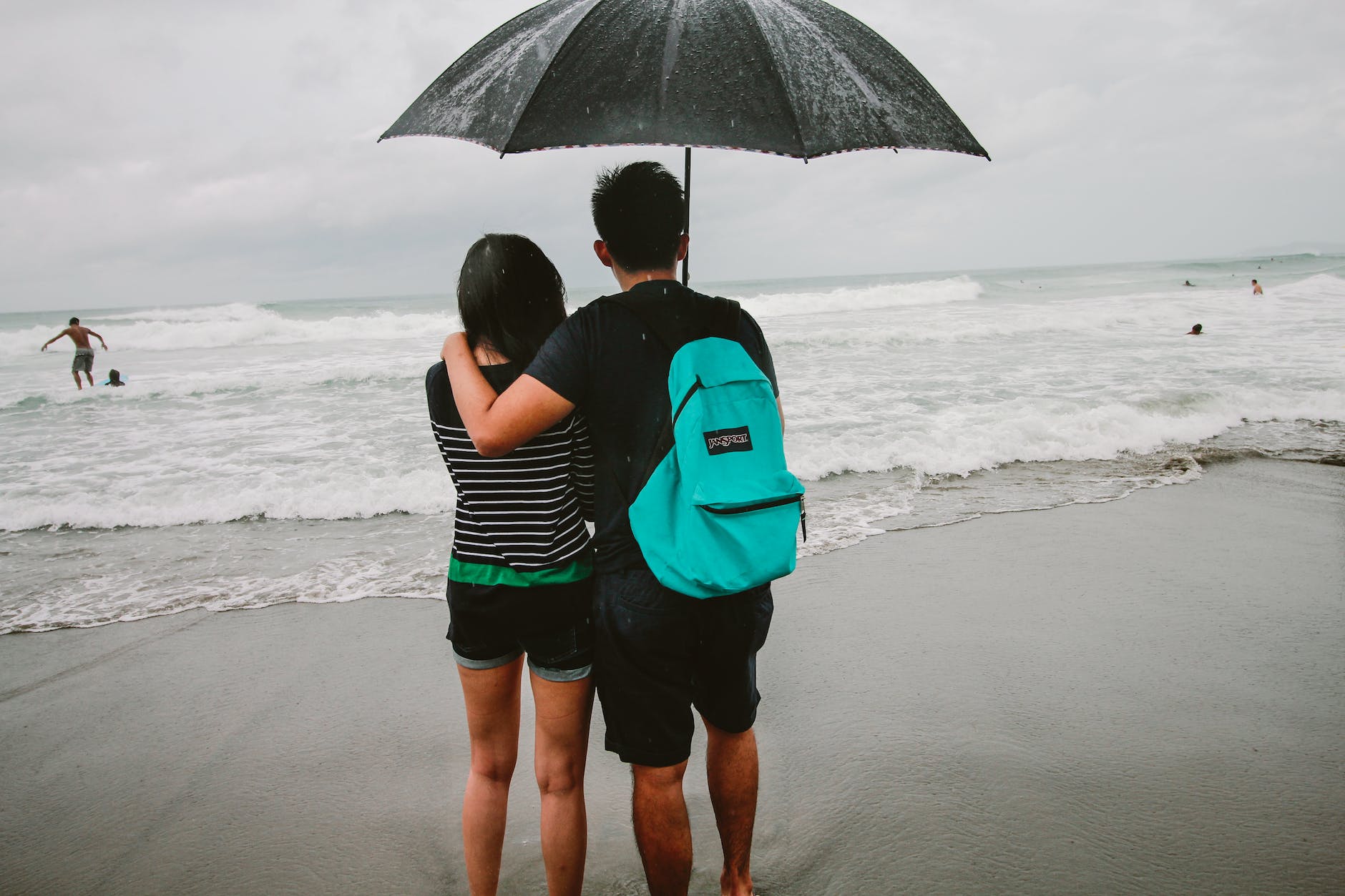 man and woman standing on shore