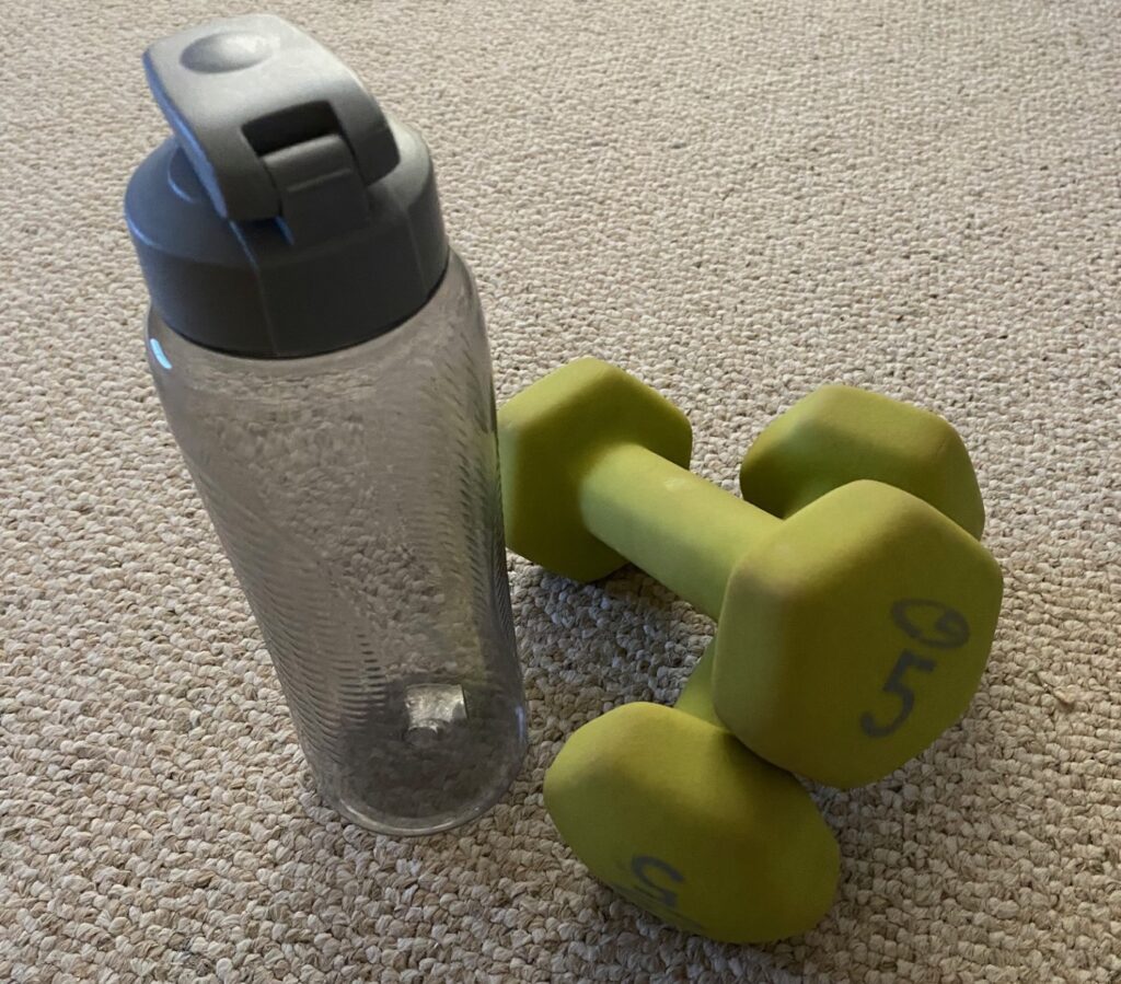 a water bottle and some weights for exercise