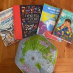 a blow up globe, and 4 books having to do with world studies