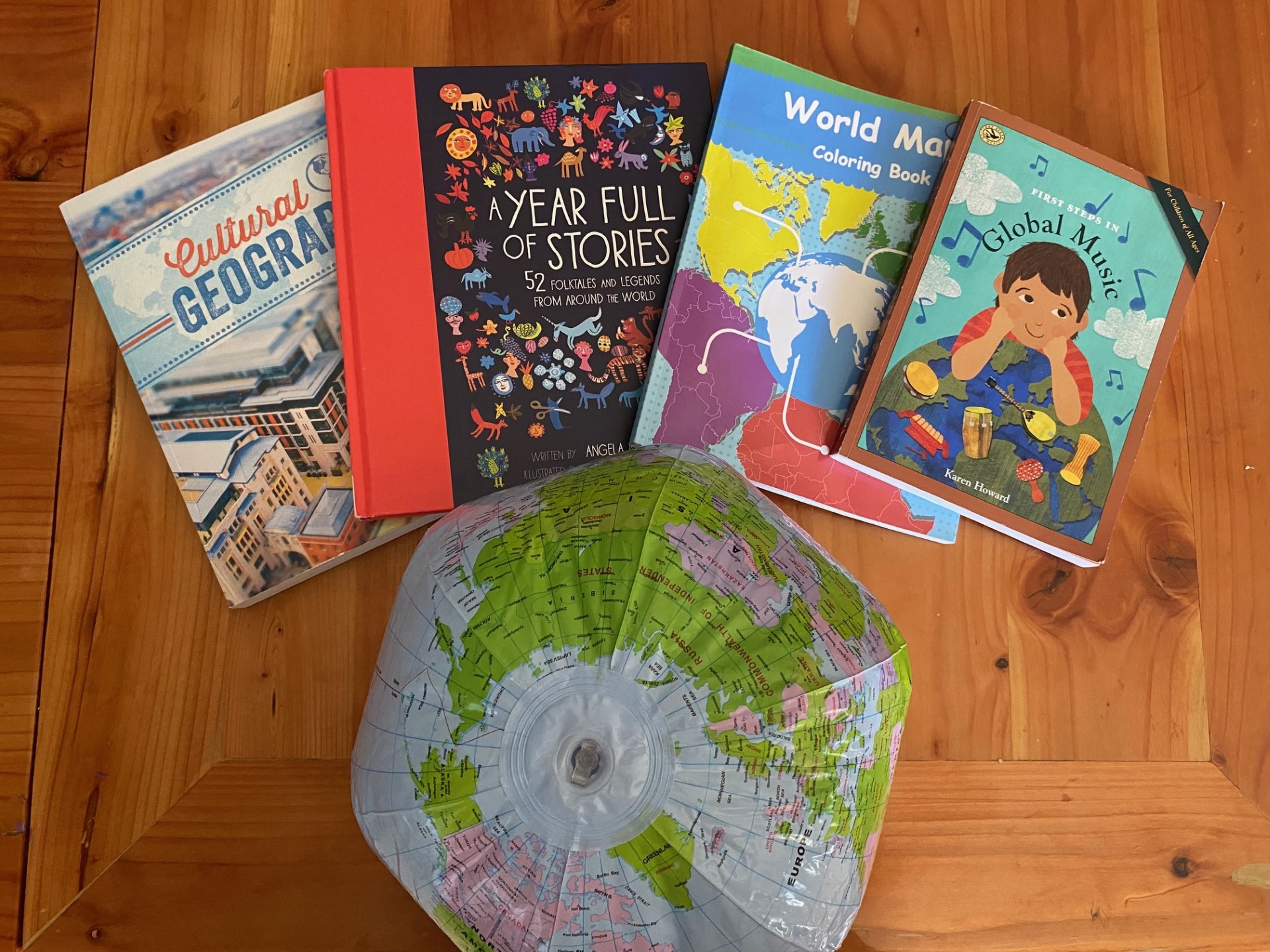 a blow up globe, and 4 books having to do with world studies