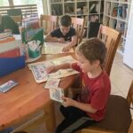 children doing school work at a table