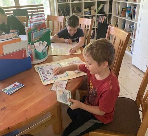 children doing school work at a table