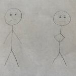 stick figures, one with a sympathetic face, one with an angry face