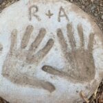 A man's and woman's handprint in cement