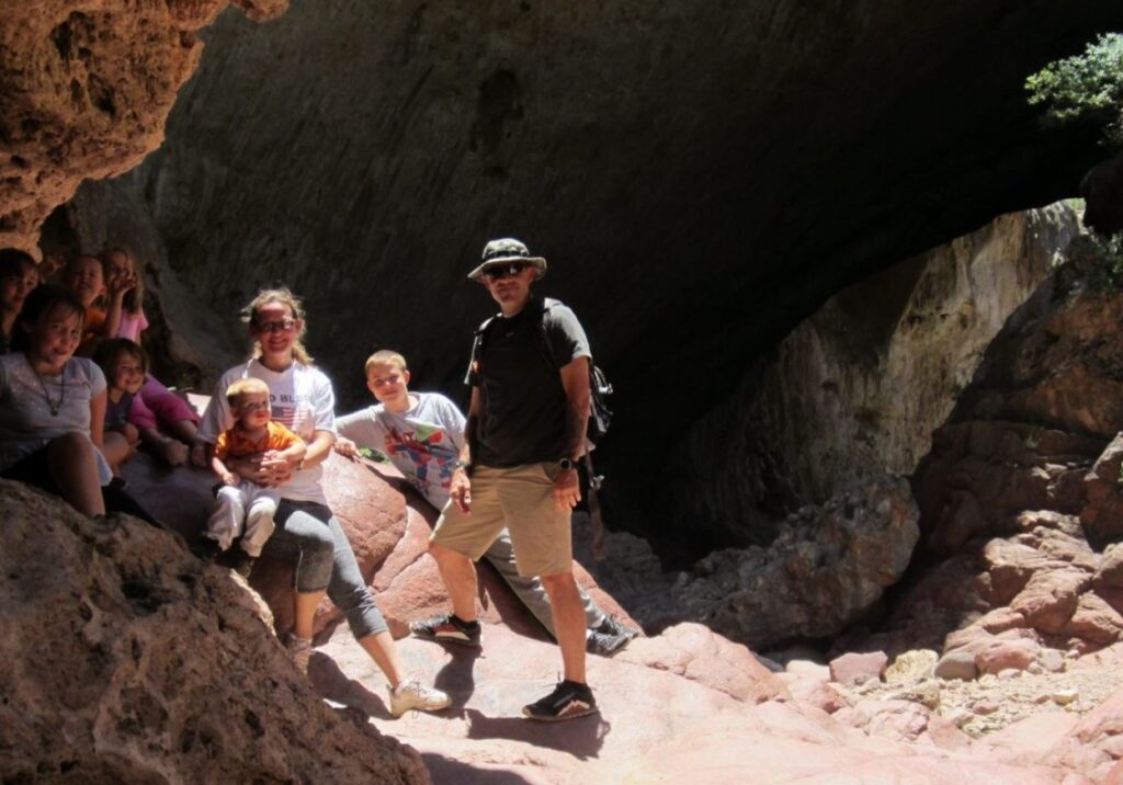 A man, woman, and their 7 kids on an outdoor adventure