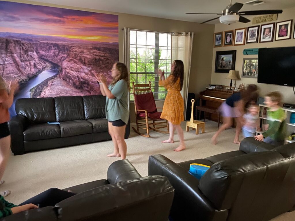 teenage girls dancing in a living-room