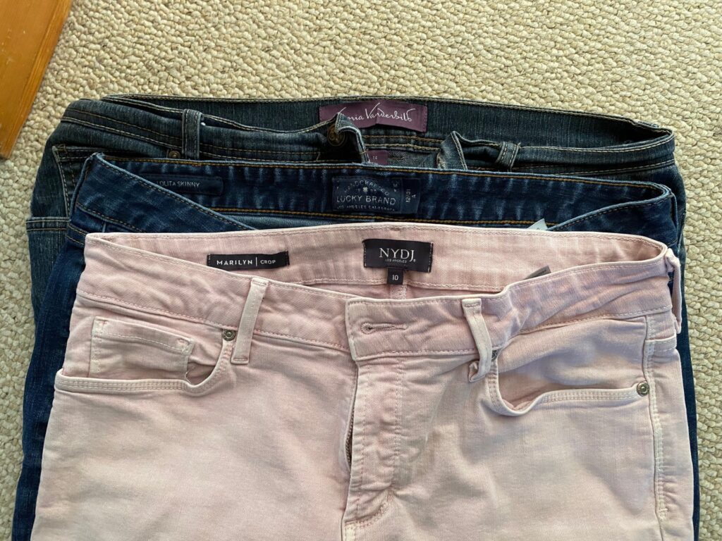 three pairs of pants in 3 sizes, focused on the waist