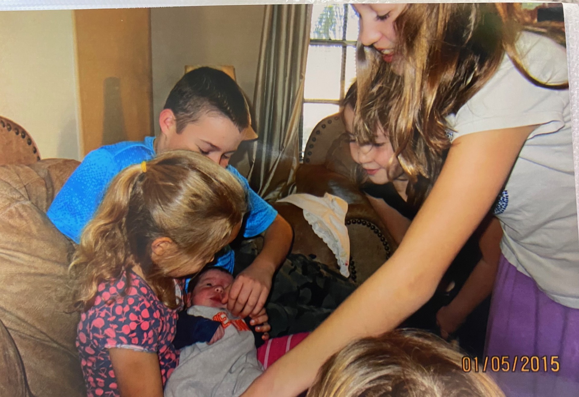 kids crowded around a baby