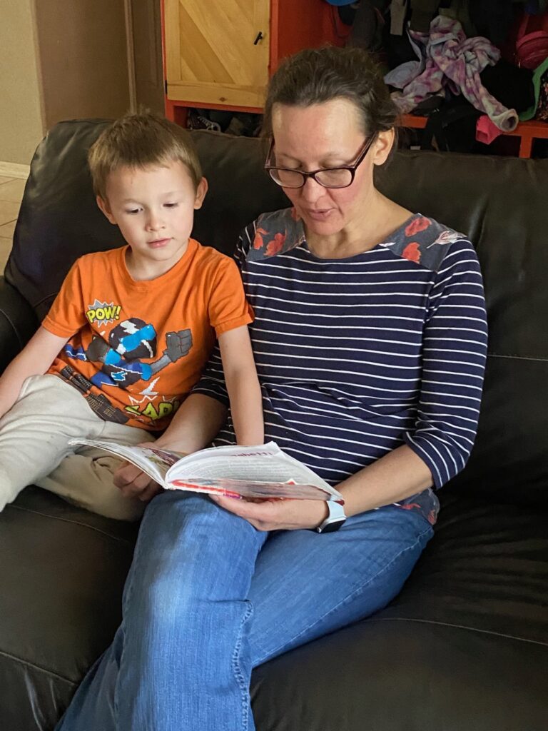 A woman and boy enjoying a book