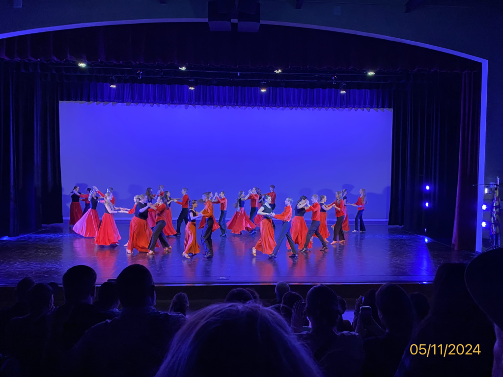 a group of ballroom dancers on a stage