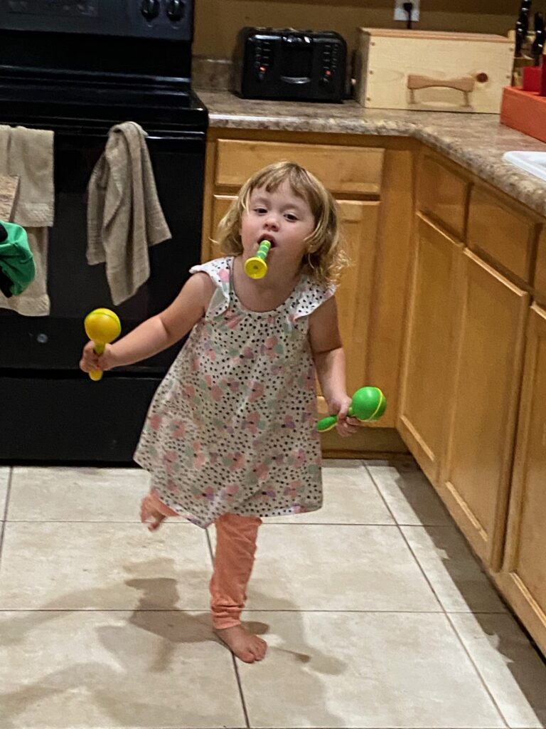 a little girls running and playing instruments