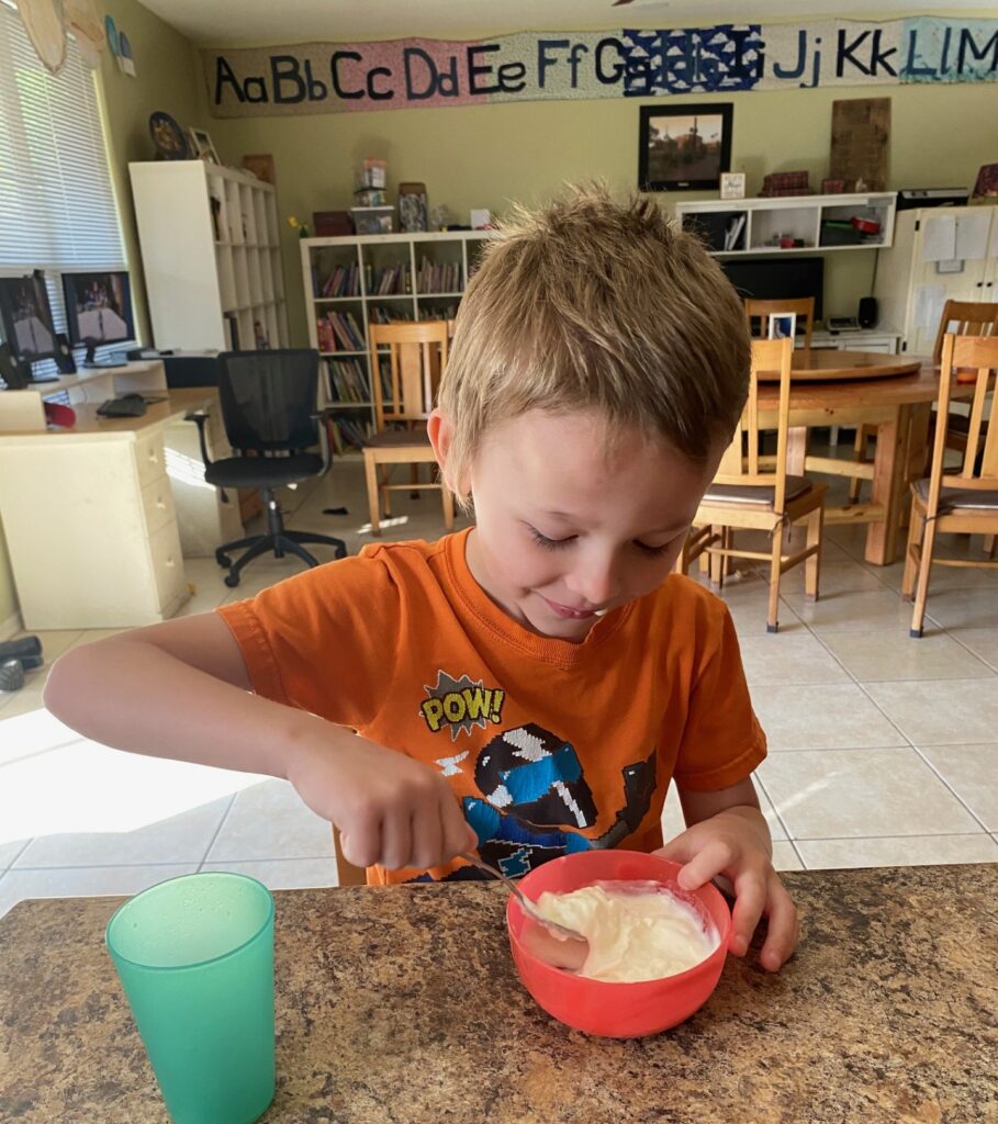 Little boy eating yogurt