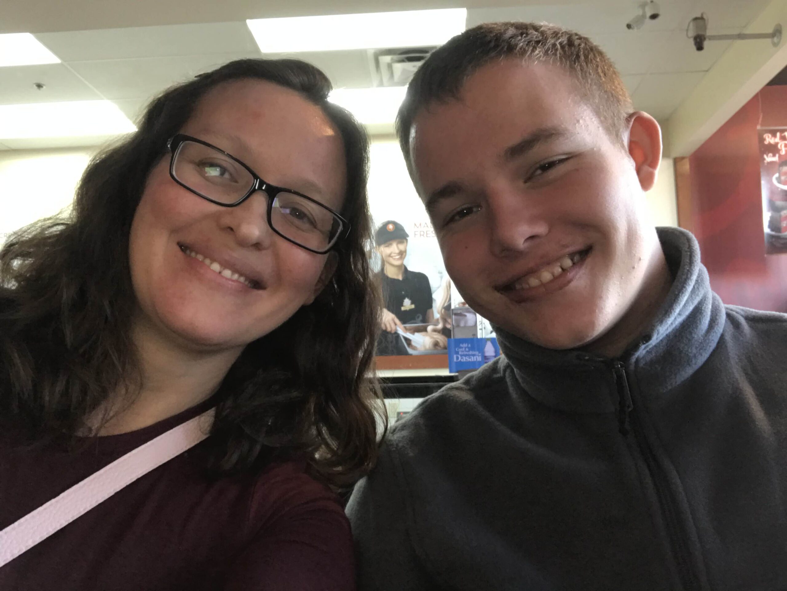 Mom and teen boy smiling for a selfie together