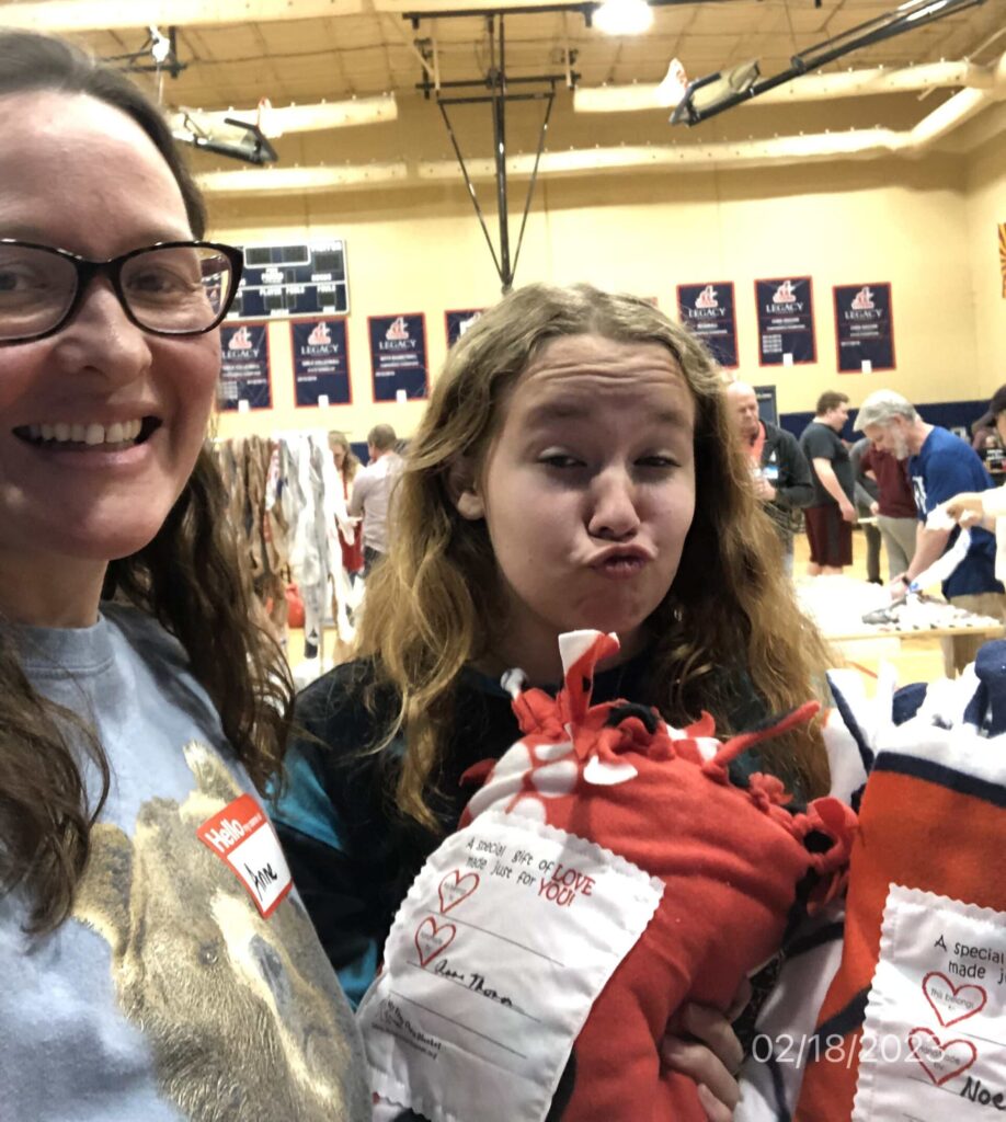 Mom and teen girl taking a selfie at a service event