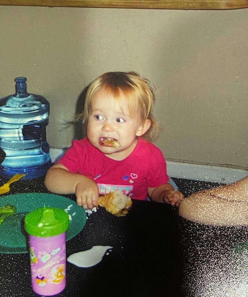 toddler eating a chicken drumstick