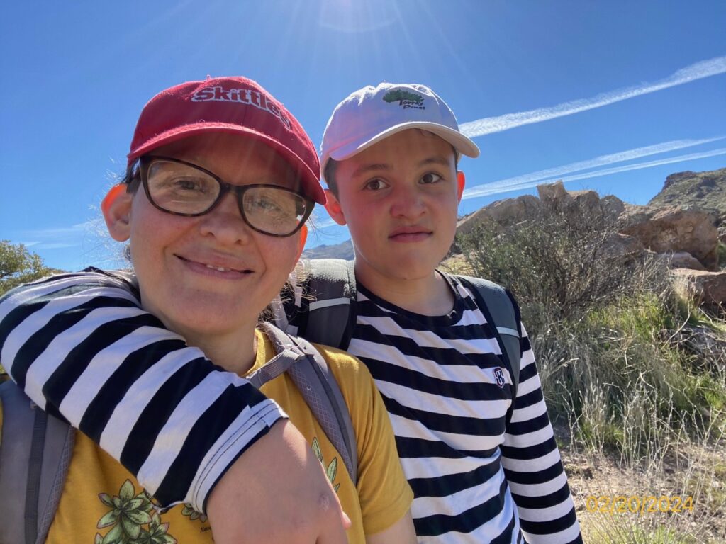 Mom and teen boy taking a selfie on a hike