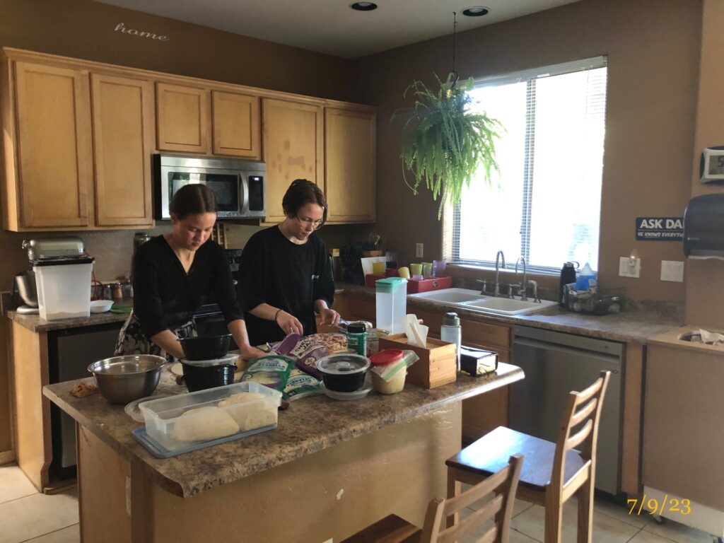 2 teenage sisters cooking